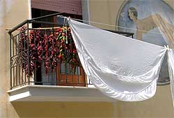 Chiles and linen drying on a balcony