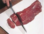 cutting baby beef into steaks