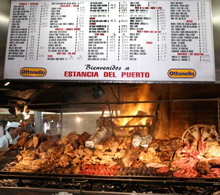 A typical mercado menu describes various cuts with prices.